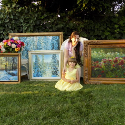Hillary T Hibbard and daughter Clara with paintings